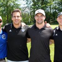 3 men in black and one in blue